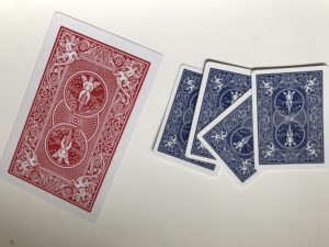 Cards thru newspaper magic trick
