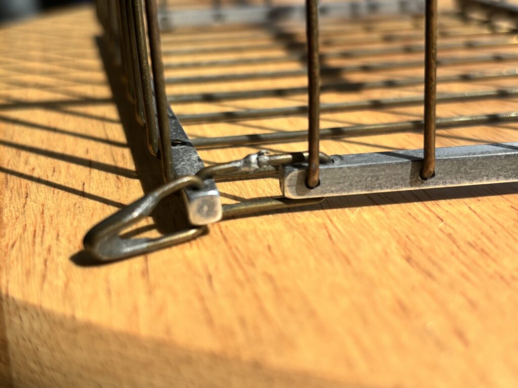 metal hinge of a magicians vanishing birdcage