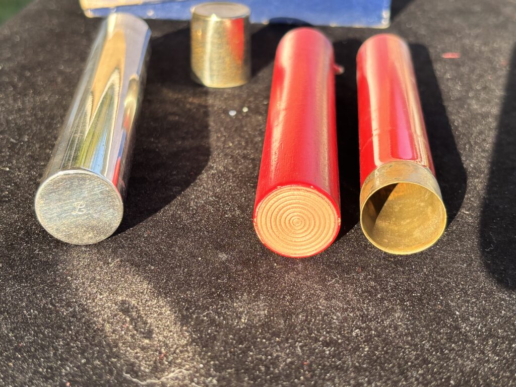 metal tube with cap and two firecrackers for a magic trick