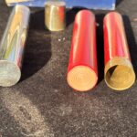 metal tube with cap and two firecrackers for a magic trick