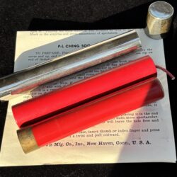 metal tube with cap and two firecrackers for a magic trick