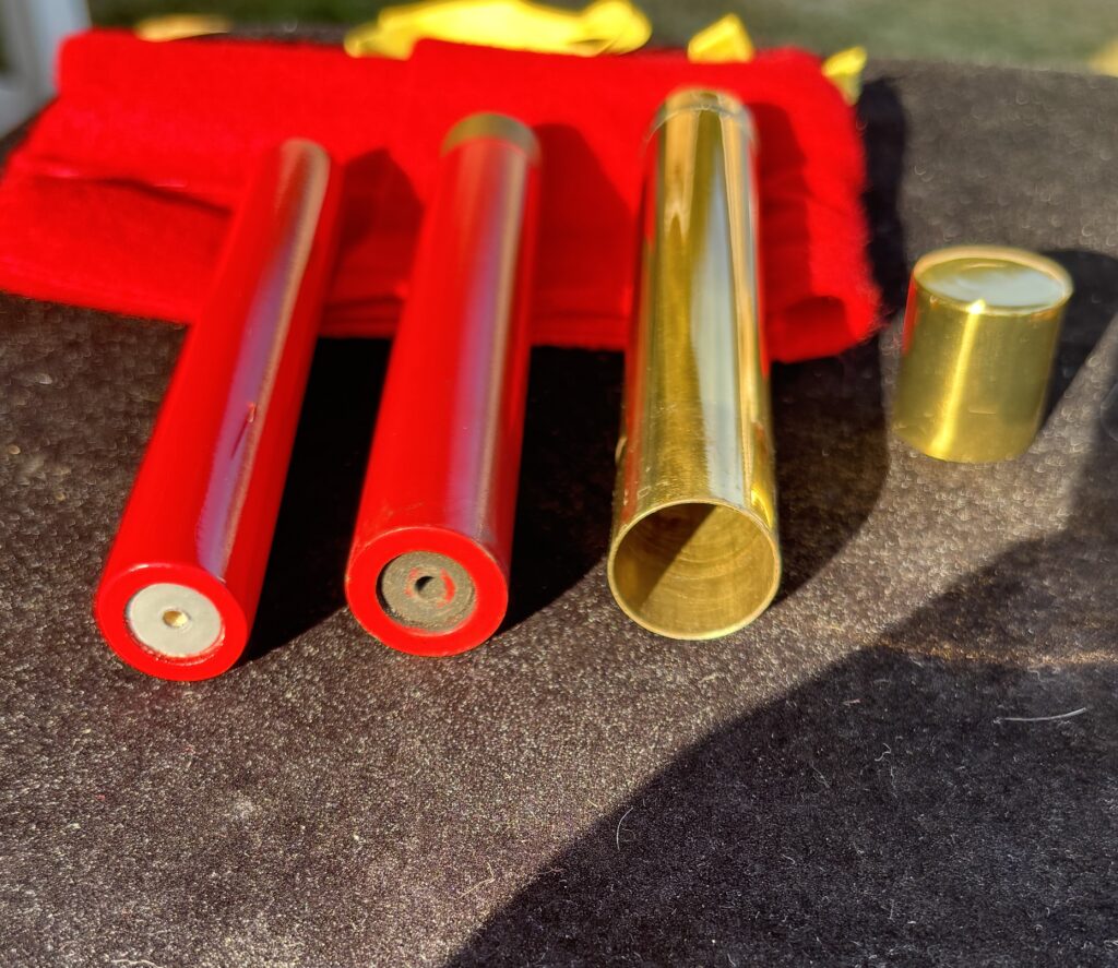 brass tube with cap and two firecrackers for a magic trick