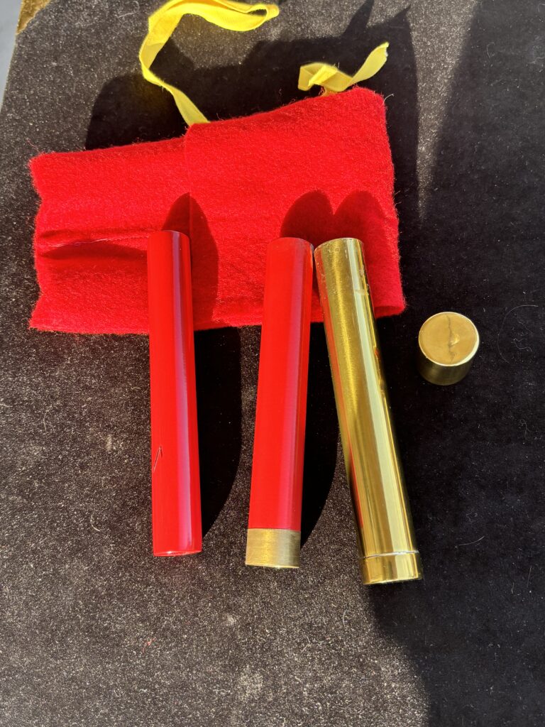 brass tube with cap and two firecrackers for a magic trick