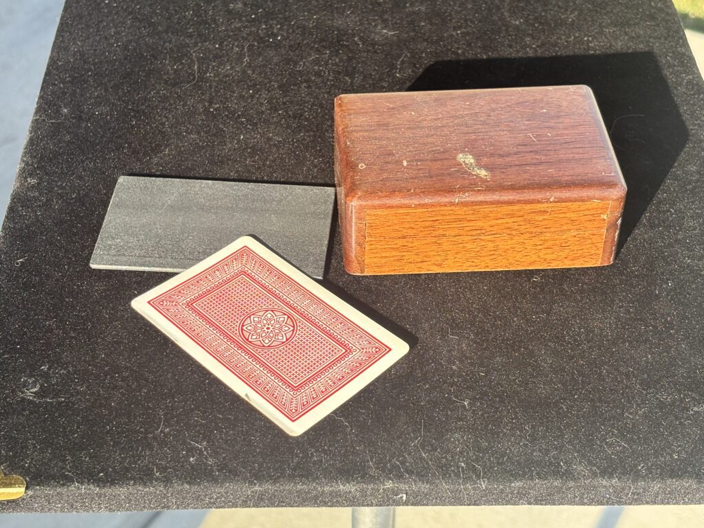 wooden box for holding playing cards for a magic trick
