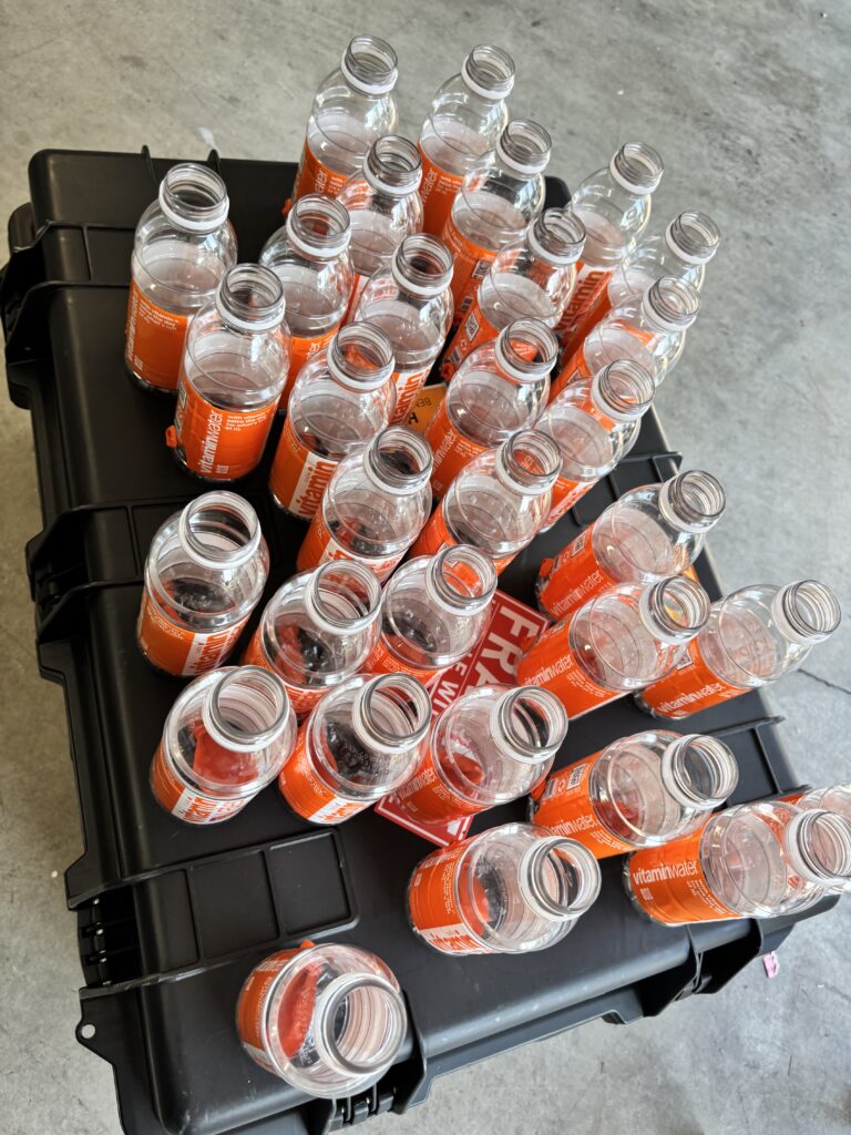 sports drink bottles for magic shows on a black case