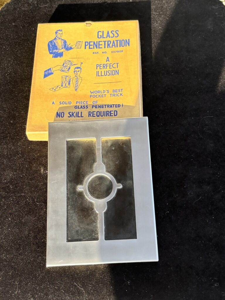metal frame with glass and vintage magic trick box