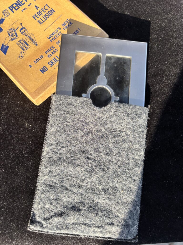 metal frame with glass and vintage magic trick box