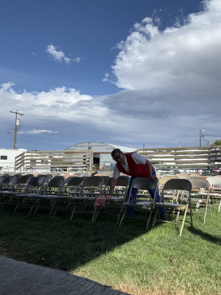 magician wiping water off of folding chair