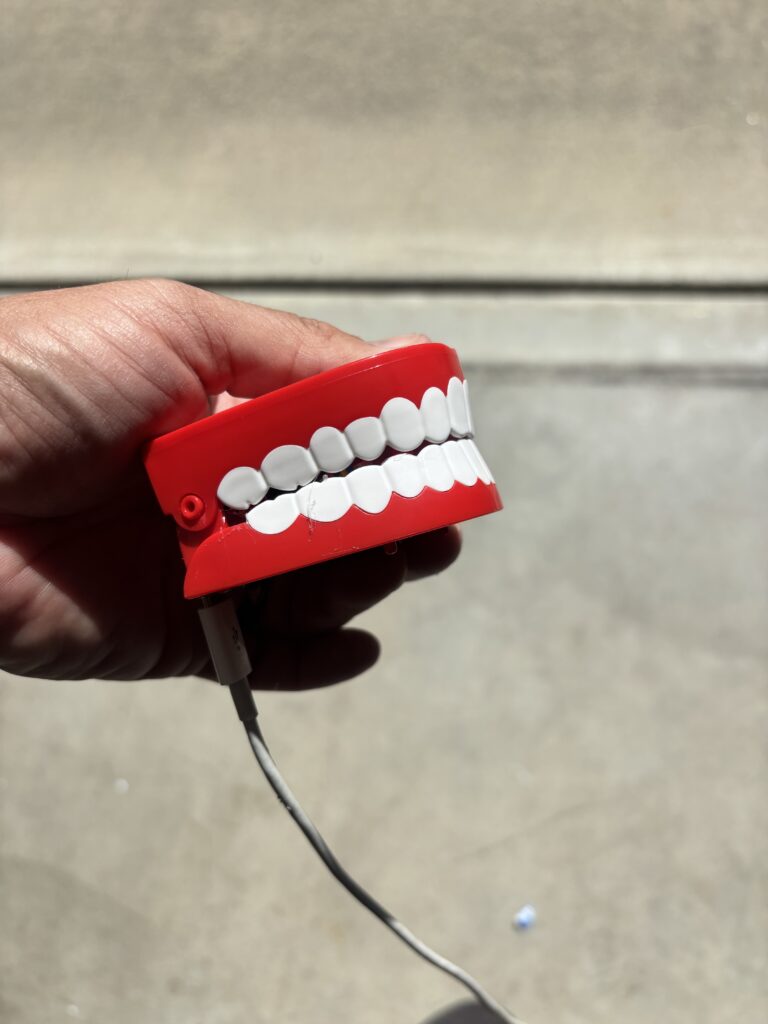 joke remote control chattering teeth, with a cord plugged into them